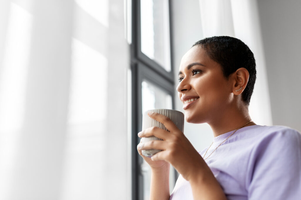 woman drinking coffee look out the window