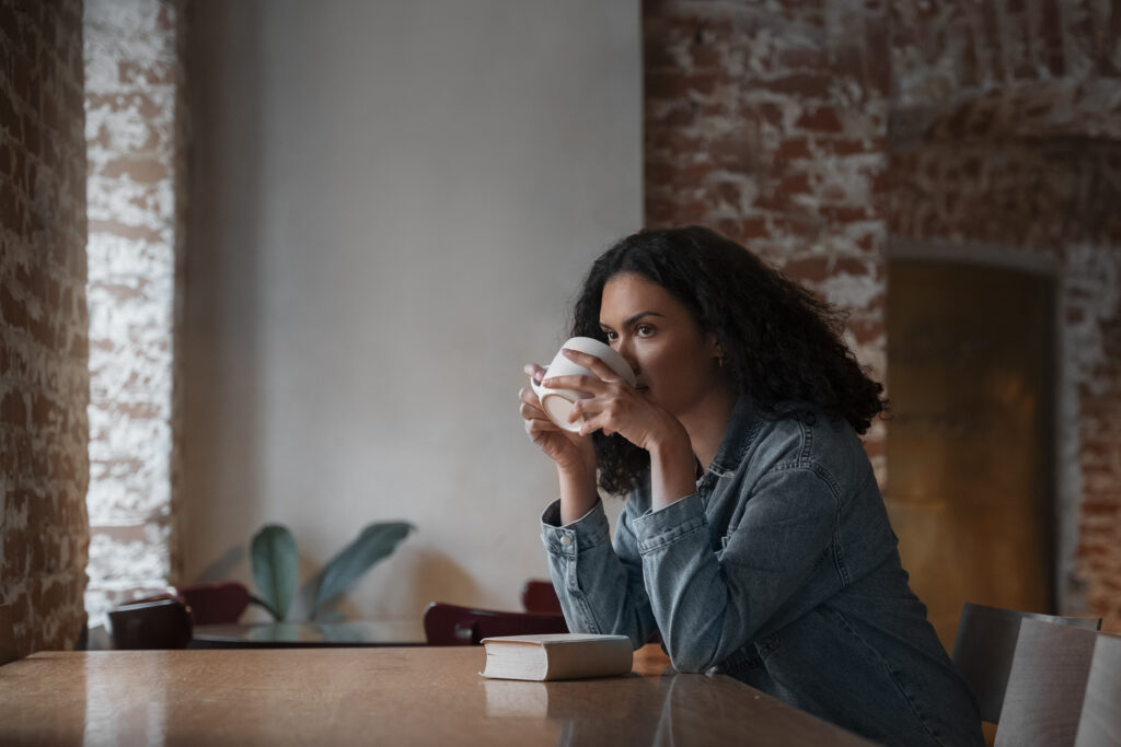 Woman enjoying coffee, thinking and reflecting on the past weeks learning opportunities.