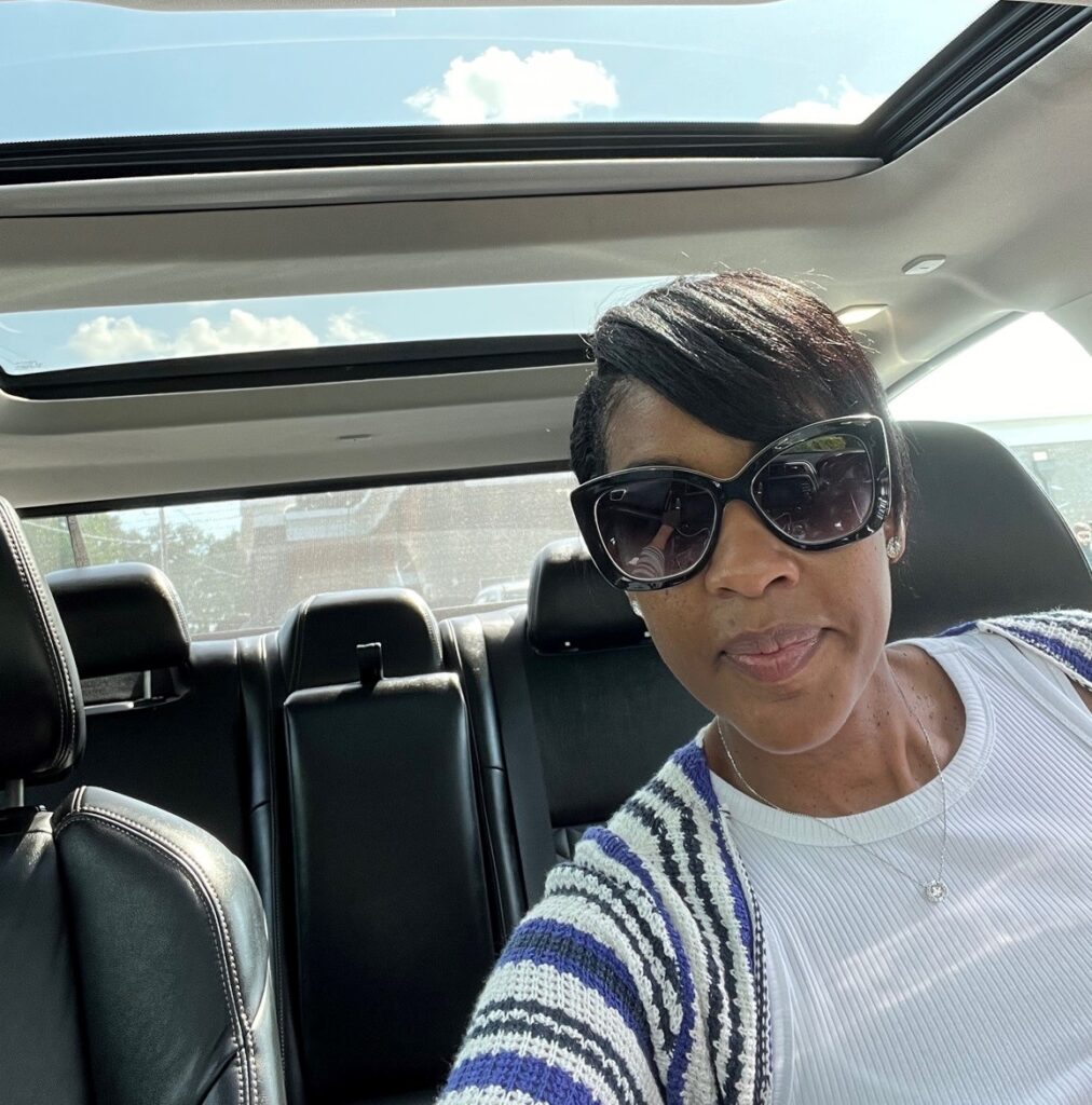 Sherry Pulcher in the car listening to smooth jazz.